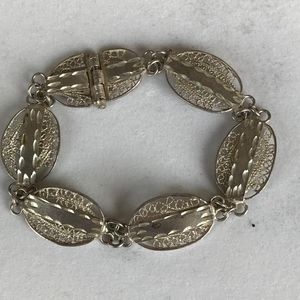 Silver bracelet. Oval links with filagree design and etched bars. 7". New